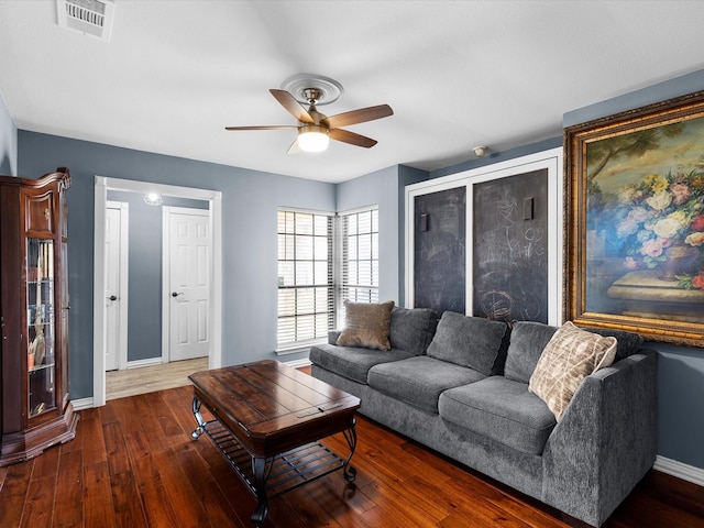 living room with wood finished floors, baseboards, a ceiling fan, and visible vents