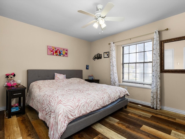 bedroom featuring wood finished floors, baseboards, and ceiling fan