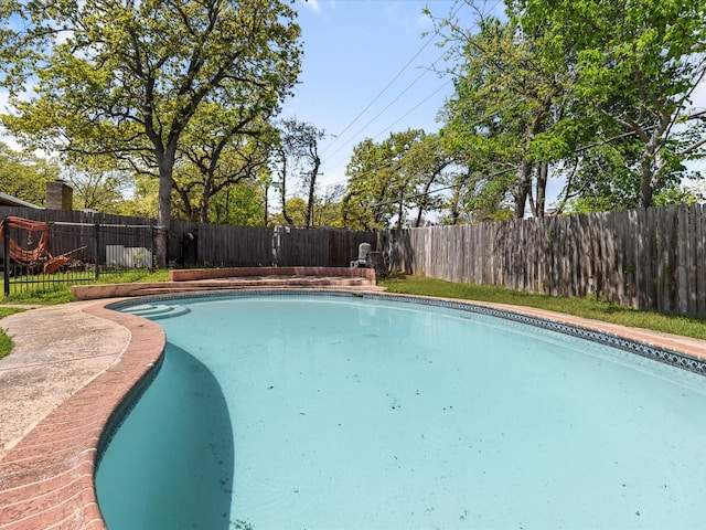 view of swimming pool with a fenced backyard and a fenced in pool
