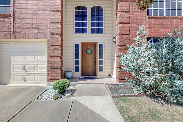 8202 Silverton Dr, Arlington, TX 76001 - entrance to property featuring driveway, a garage, and brick siding