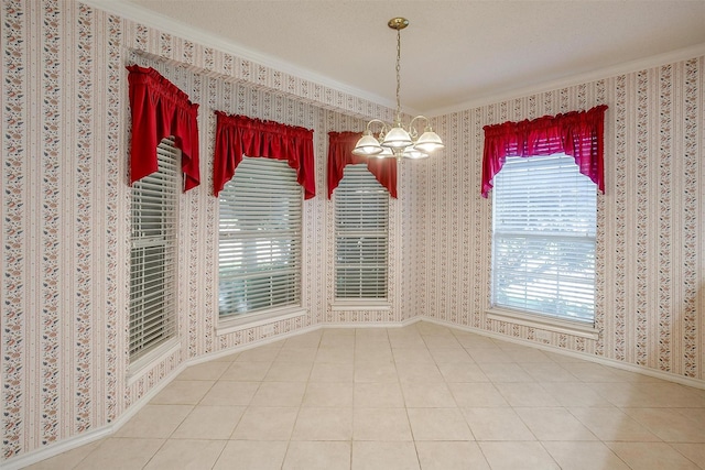 unfurnished dining area with crown molding, tile patterned flooring, a chandelier, and a healthy amount of sunlight