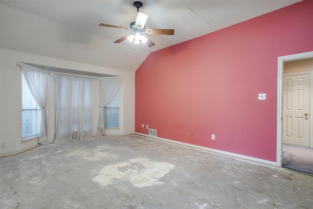 interior space featuring lofted ceiling, baseboards, unfinished concrete floors, and ceiling fan