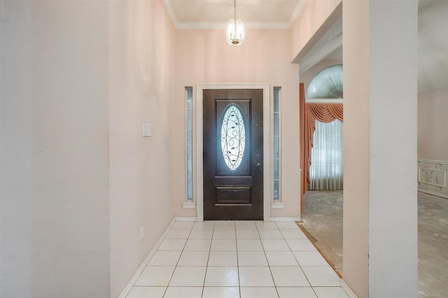 foyer entrance featuring tile patterned flooring, crown molding, and baseboards
