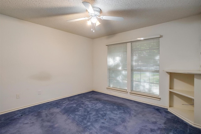 carpeted empty room with a textured ceiling and a ceiling fan