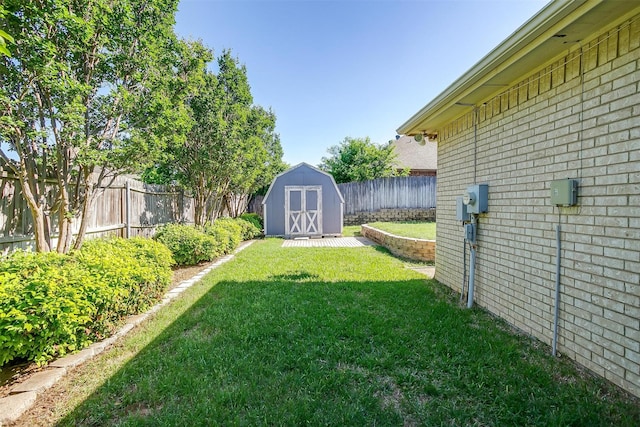 view of yard featuring a fenced backyard, an outbuilding, and a storage shed