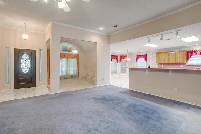 carpeted entrance foyer with plenty of natural light, baseboards, and visible vents