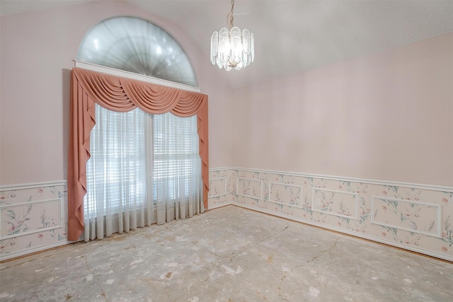 unfurnished room featuring an inviting chandelier