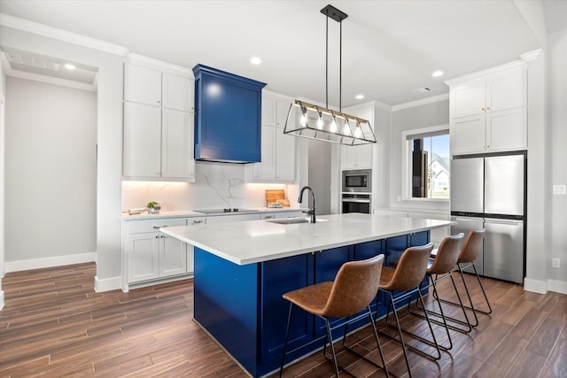 kitchen with a sink, stainless steel appliances, baseboards, light countertops, and ornamental molding