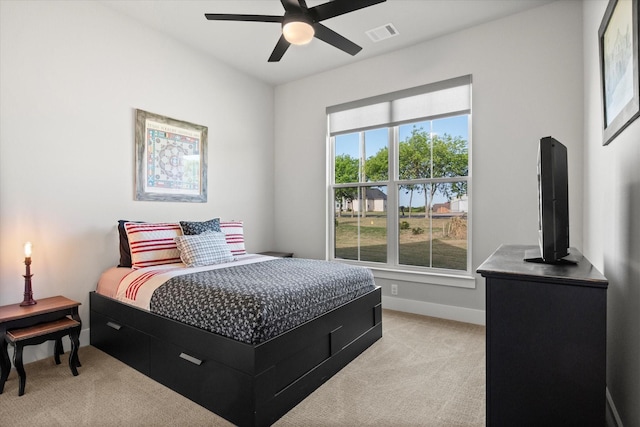 bedroom featuring light colored carpet, visible vents, baseboards, and multiple windows