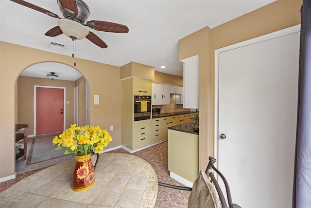 1803 Michael Ct, Arlington, TX 76010 - dining space featuring arched walkways, a ceiling fan, and baseboards