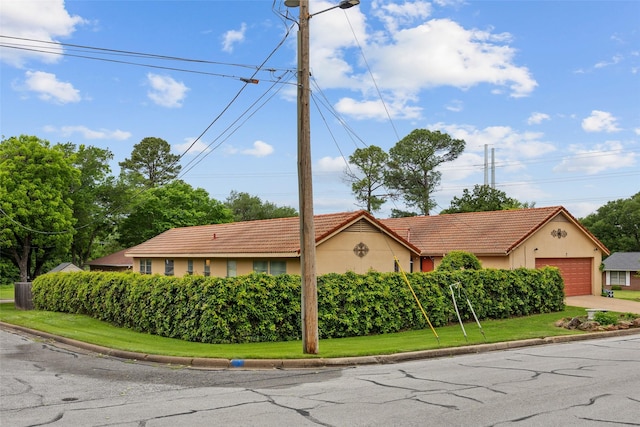1803 Michael Ct, Arlington, TX 76010 - view of front of property with stucco siding, concrete driveway, a tile roof, and a garage