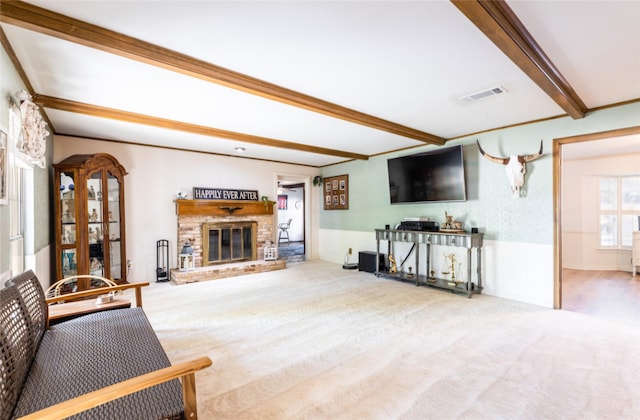living room with visible vents, beam ceiling, carpet, and a fireplace