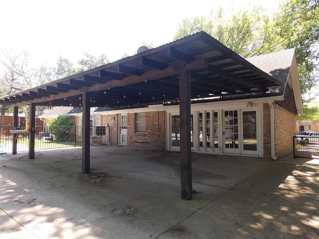 view of patio / terrace with fence and a carport