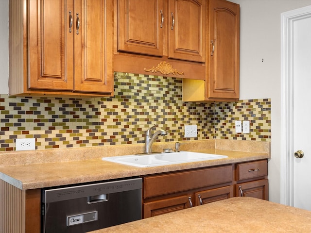 kitchen featuring a sink, light countertops, stainless steel dishwasher, and tasteful backsplash