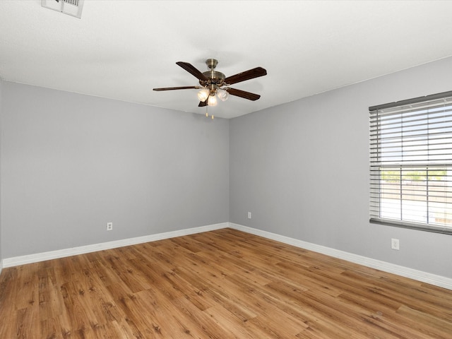 unfurnished room with light wood-style flooring, ceiling fan, baseboards, and visible vents