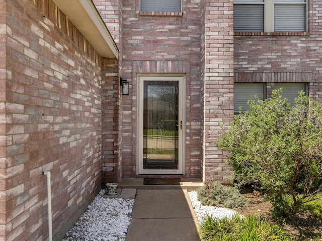 entrance to property with brick siding