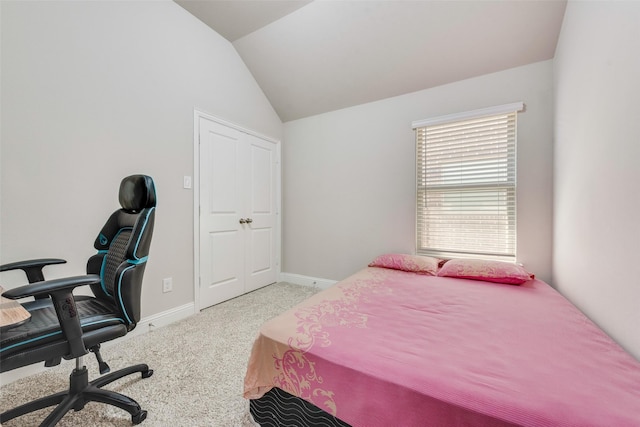 carpeted bedroom featuring vaulted ceiling and baseboards