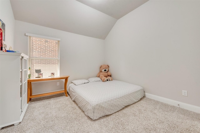 carpeted bedroom featuring vaulted ceiling and baseboards