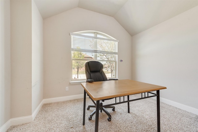 carpeted home office featuring baseboards and vaulted ceiling