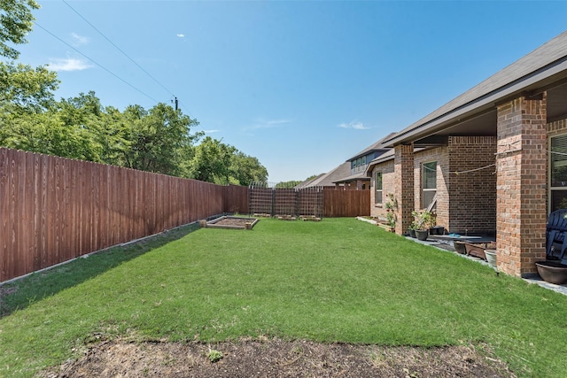 view of yard with a fenced backyard and a vegetable garden