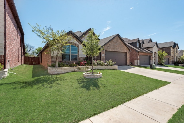 view of front of house with an attached garage, driveway, fence, and brick siding