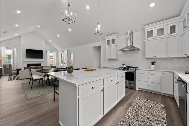 3616 Hickory St, Sherman, TX 75092 - kitchen featuring appliances with stainless steel finishes, wall chimney range hood, a kitchen island, white cabinetry, and recessed lighting
