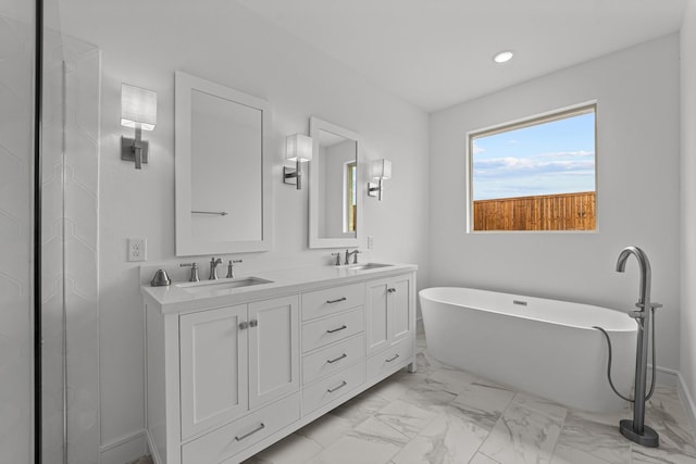 3616 Hickory St, Sherman, TX 75092 - full bathroom with marble finish floors, a soaking tub, double vanity, and recessed lighting