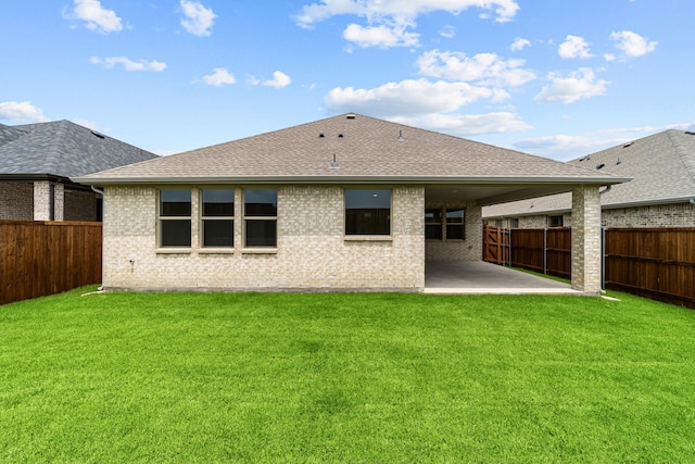 3616 Hickory St, Sherman, TX 75092 - back of property featuring a patio area, a fenced backyard, brick siding, and a shingled roof