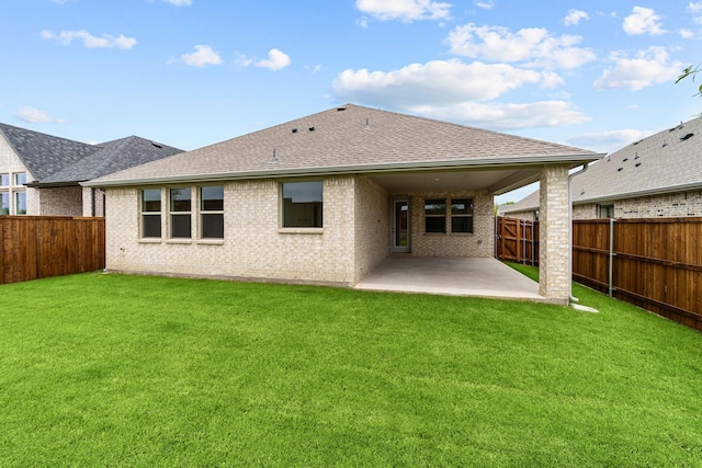 3616 Hickory St, Sherman, TX 75092 - back of property featuring a patio, a fenced backyard, a shingled roof, and brick siding