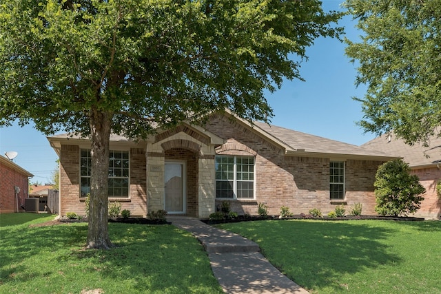 ranch-style house with brick siding, a front lawn, and central AC