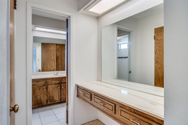 bathroom with tile patterned floors and vanity