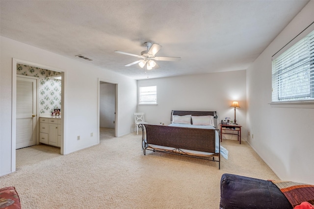 bedroom featuring visible vents, ceiling fan, and light carpet