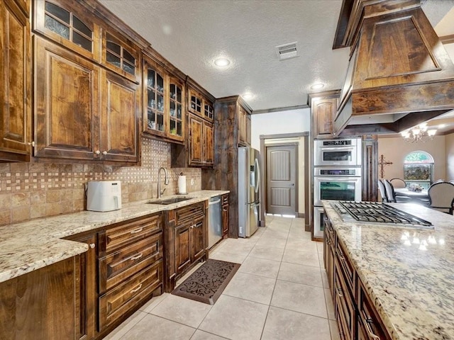 194 Royal Pnes, Lufkin, TX 75904 - kitchen with a sink, appliances with stainless steel finishes, backsplash, a chandelier, and a textured ceiling