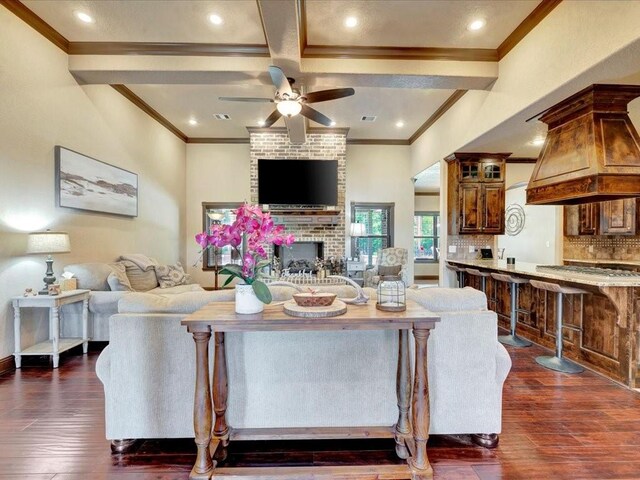 194 Royal Pnes, Lufkin, TX 75904 - living area with crown molding, a ceiling fan, dark wood-type flooring, beamed ceiling, and a fireplace