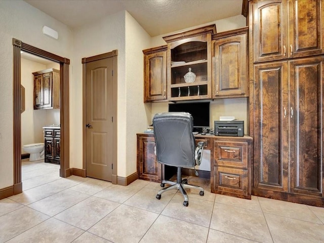 194 Royal Pnes, Lufkin, TX 75904 - office area with built in desk, light tile patterned flooring, and baseboards