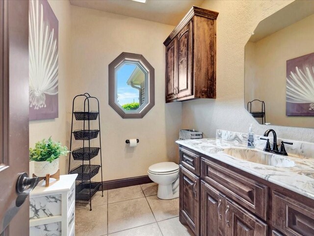 194 Royal Pnes, Lufkin, TX 75904 - bathroom featuring tile patterned floors, toilet, vanity, and baseboards