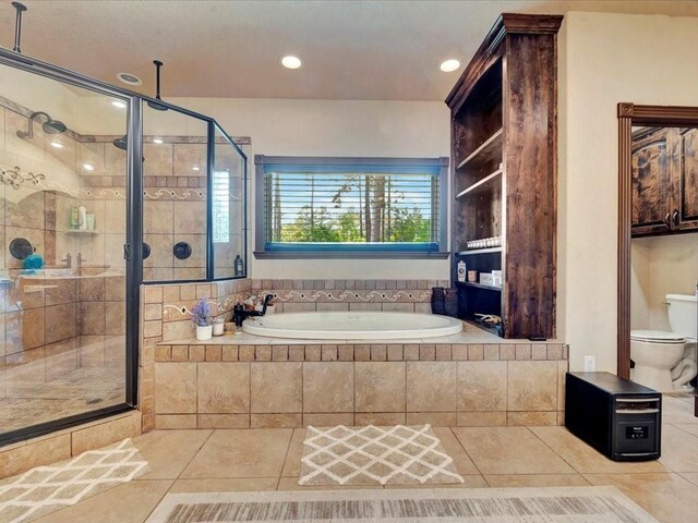 194 Royal Pnes, Lufkin, TX 75904 - bathroom featuring tile patterned flooring, a stall shower, a bath, recessed lighting, and toilet