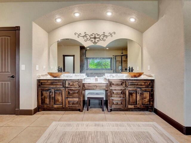194 Royal Pnes, Lufkin, TX 75904 - bathroom featuring vanity, a textured wall, tile patterned flooring, baseboards, and a shower