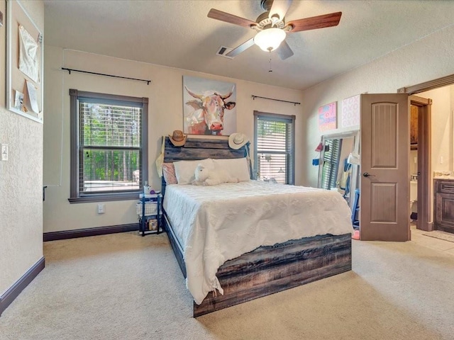 194 Royal Pnes, Lufkin, TX 75904 - carpeted bedroom featuring multiple windows, a textured ceiling, a textured wall, ceiling fan, and baseboards