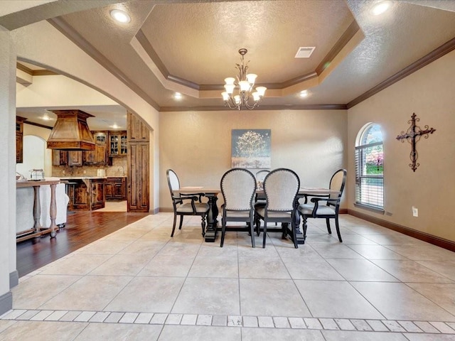 194 Royal Pnes, Lufkin, TX 75904 - dining room with a raised ceiling, a chandelier, ornamental molding, light tile patterned floors, and a textured ceiling