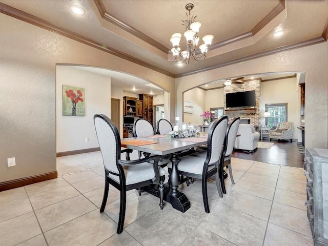 194 Royal Pnes, Lufkin, TX 75904 - dining room with ornamental molding, a textured wall, a chandelier, arched walkways, and ceiling fan