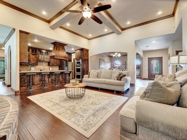 194 Royal Pnes, Lufkin, TX 75904 - living room with arched walkways, a ceiling fan, ornamental molding, beamed ceiling, and wood finished floors