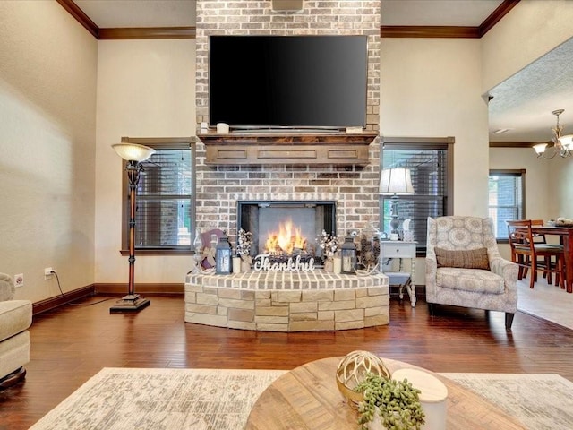 194 Royal Pnes, Lufkin, TX 75904 - living room with ornamental molding, wood finished floors, a fireplace, baseboards, and a chandelier