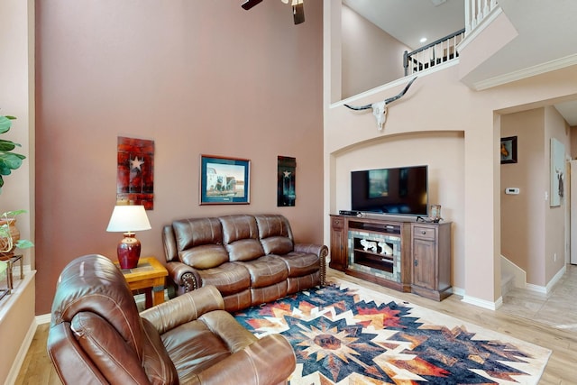 6948 Carrington Ln, Fort Worth, TX 76137 - living area with baseboards, light wood finished floors, a towering ceiling, and a ceiling fan
