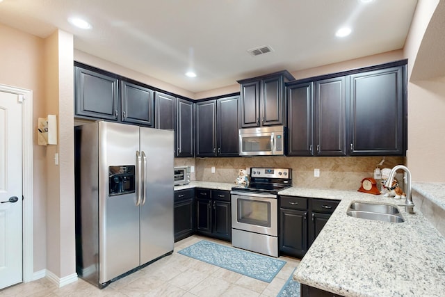 6948 Carrington Ln, Fort Worth, TX 76137 - kitchen with tasteful backsplash, appliances with stainless steel finishes, a sink, and visible vents