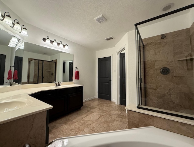 6948 Carrington Ln, Fort Worth, TX 76137 - bathroom featuring visible vents, a shower stall, vanity, and a textured ceiling