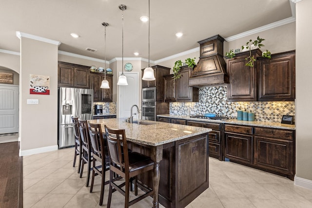4304 Caney Creek Cir, Celina, TX 75078 - kitchen featuring a sink, appliances with stainless steel finishes, light tile patterned floors, custom exhaust hood, and dark brown cabinets