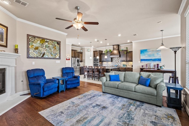 4304 Caney Creek Cir, Celina, TX 75078 - living area featuring visible vents, ceiling fan, baseboards, a glass covered fireplace, and ornamental molding