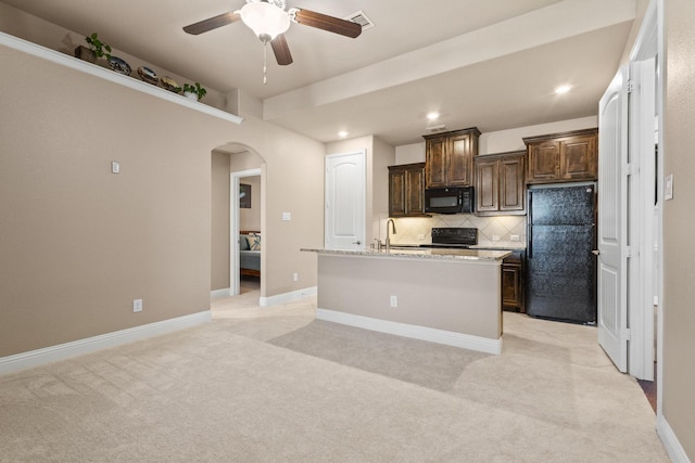 4304 Caney Creek Cir, Celina, TX 75078 - kitchen featuring black appliances, ceiling fan, arched walkways, and light carpet