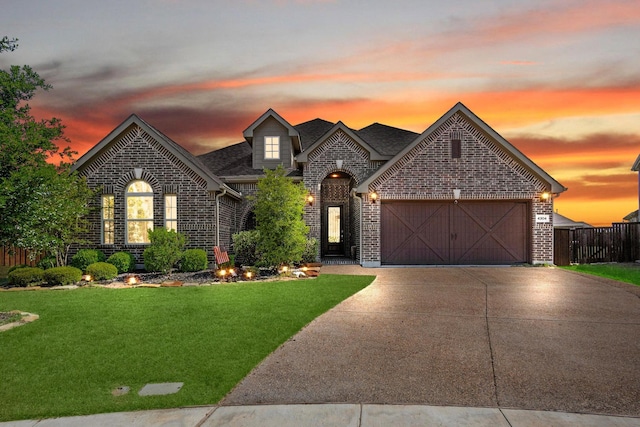 4304 Caney Creek Cir, Celina, TX 75078 - french country style house featuring a yard, brick siding, a garage, roof with shingles, and concrete driveway